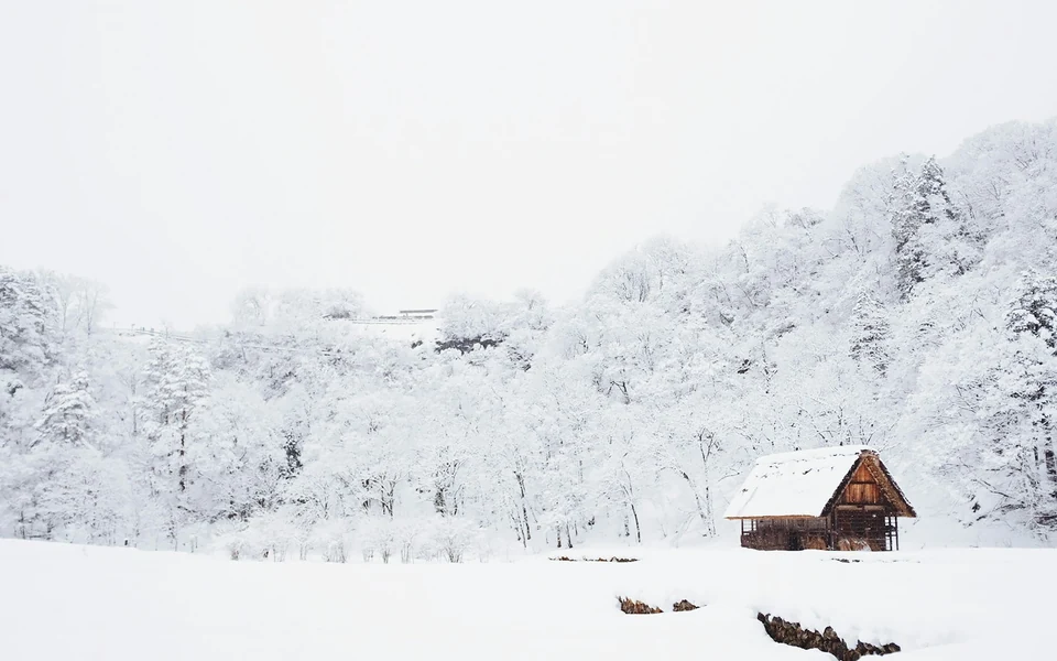 Stock photo of a rural property surrounded by snow-covered grounds and trees